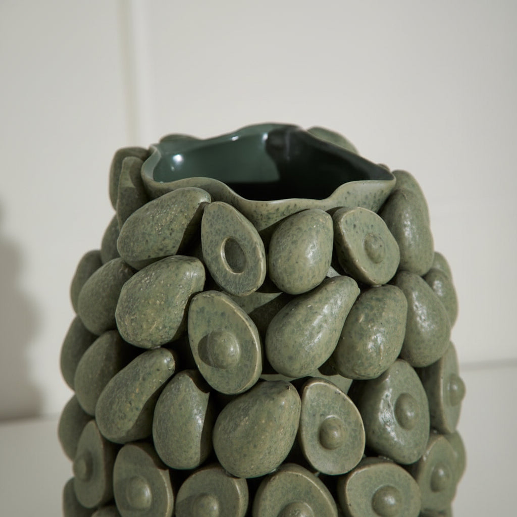 Decorative vase made of green ceramic stones with a smooth finish.