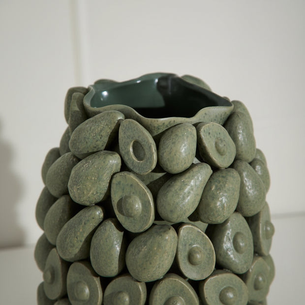 Decorative vase made of green ceramic stones with a smooth finish.